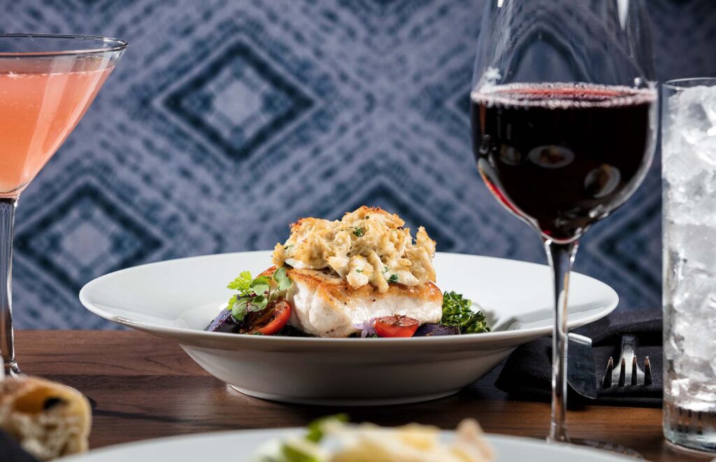 Seafood dish and wine from Euphoria Fish House at Margaritaville Resort Orlando
