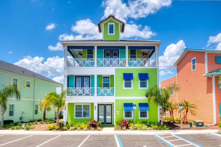 8 Bedroom Superior Cottage exterior front with two covered, wrap-around balconies, garden, and parking spaces