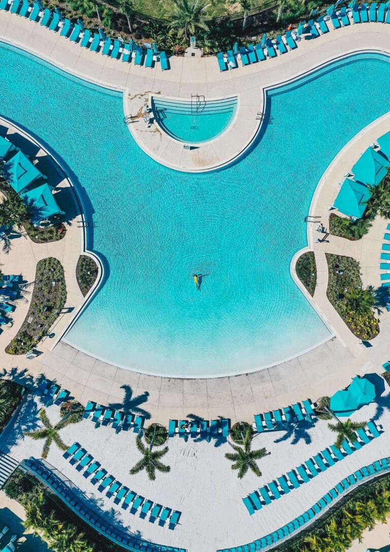 Bird’s eye view of a woman relaxing in Margaritaville Resort Orlando’s expansive zero-entry pool