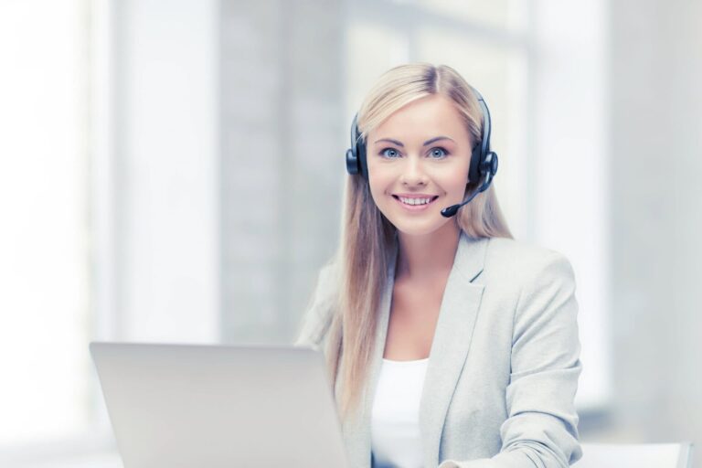 Friendly female call center operator with laptop
