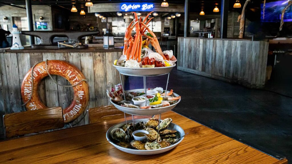 Three-tier seafood tower on a table in The Wharf at Sunset Walk restaurant