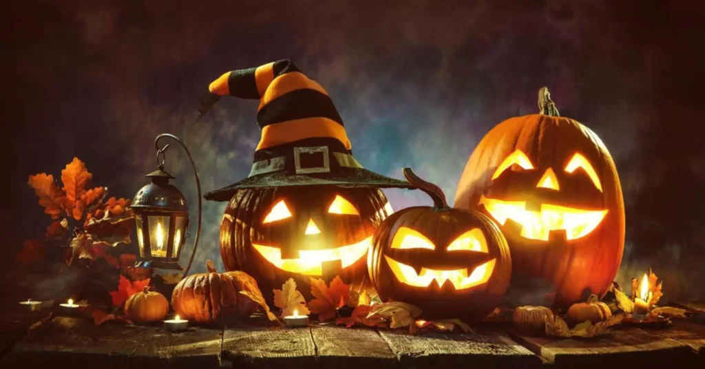 Halloween jack-o’-lanterns with fall leaves and accessories